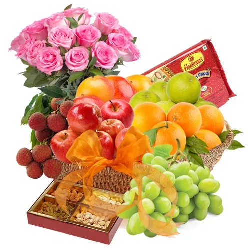 Elegance of Fresh Fruits Basket with Tasty Haldiram Soan papdi and Rose Bouquet