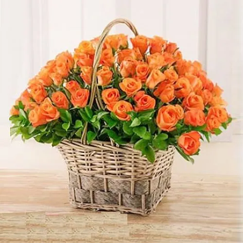 Blushing Basket of Oranges Roses with Green Leaves