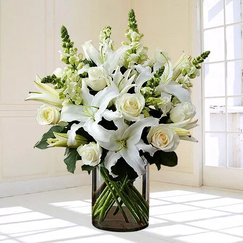 Touching White Flowers in Glass Vase for Peaceful Remembrance