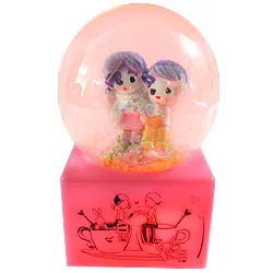 Ravishing Love Couple in LED Lighted Glass Globe with Floating Tinsel